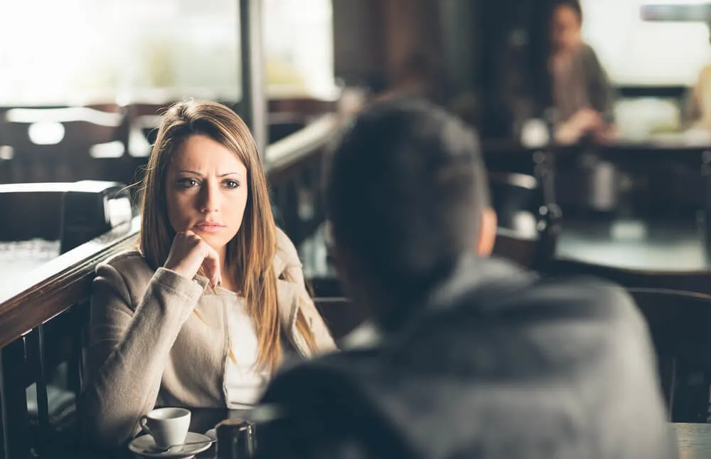 woman looking at the man in the bar