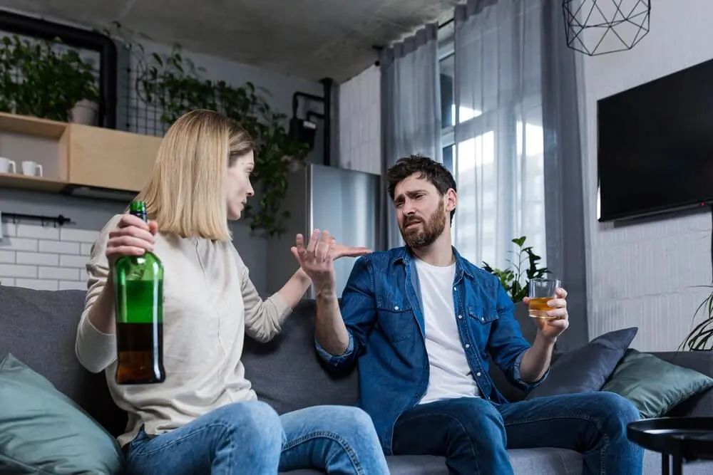 Woman telling husband to stop drinking alcohol