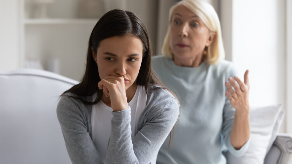 Girl annoyed by authoritative lecturing senior mother.