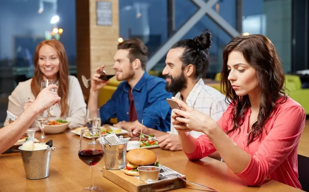 bored woman dining with friends