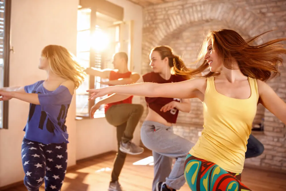 Young dancers dancing together in dancing studio