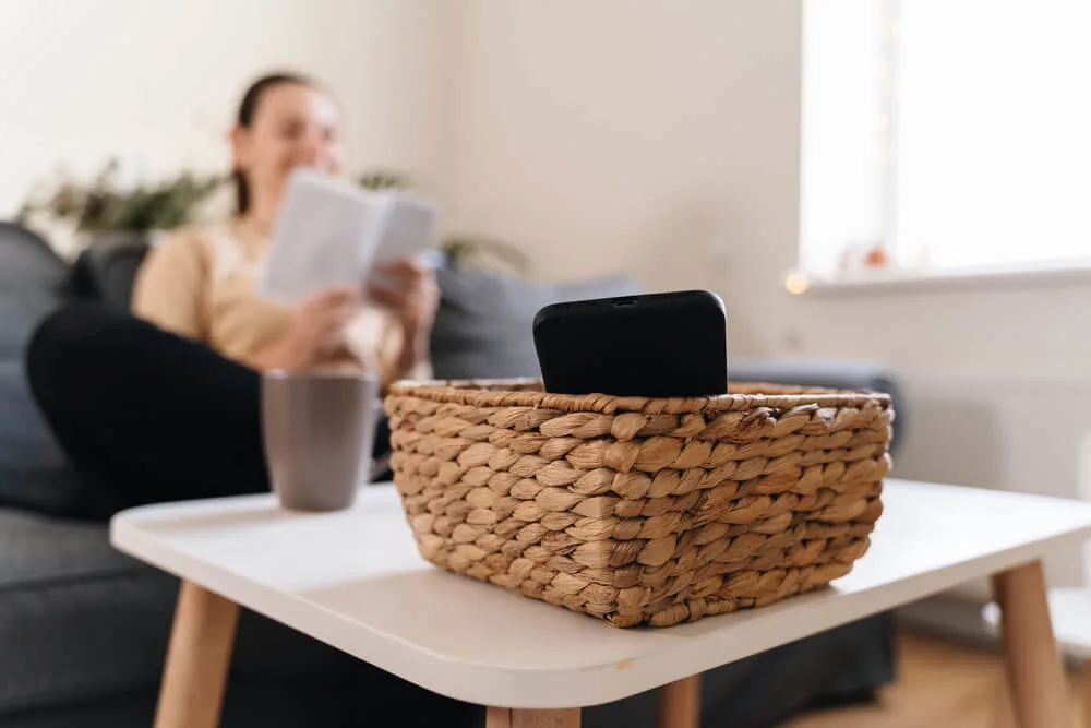 Girl at home refuse using phone and reading a book