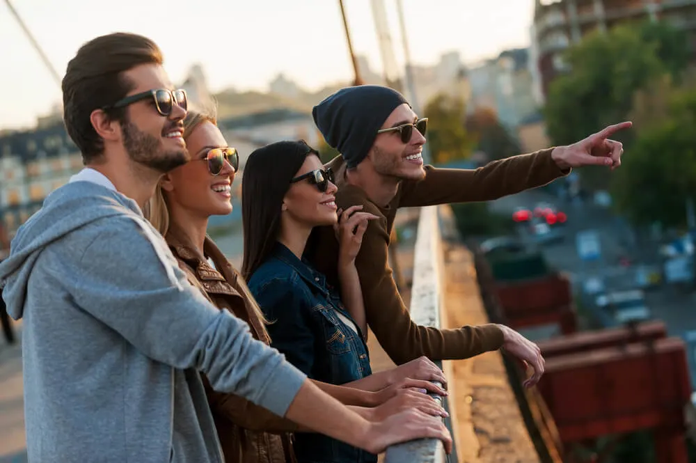 Group of young people standing close to each other on the bridge