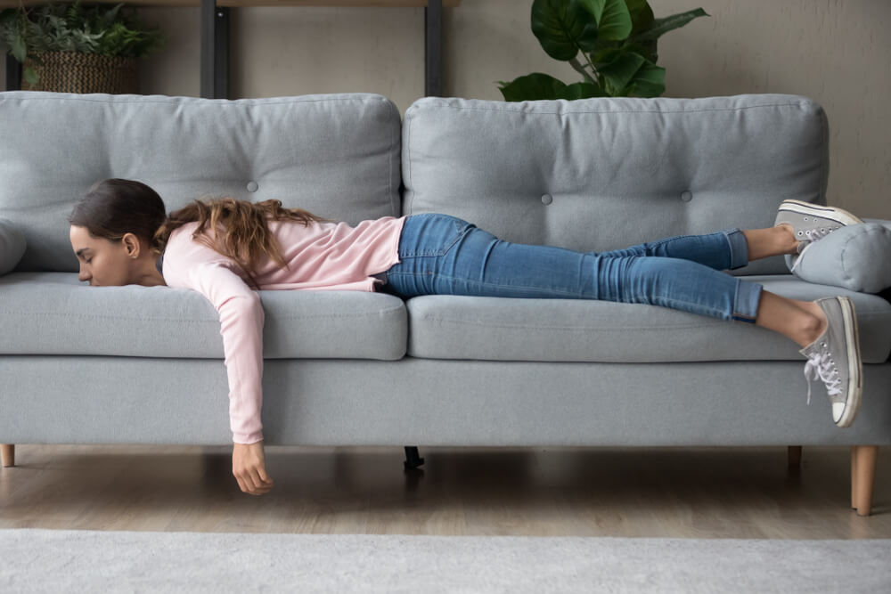 Full length of girl lying rest at home in living room