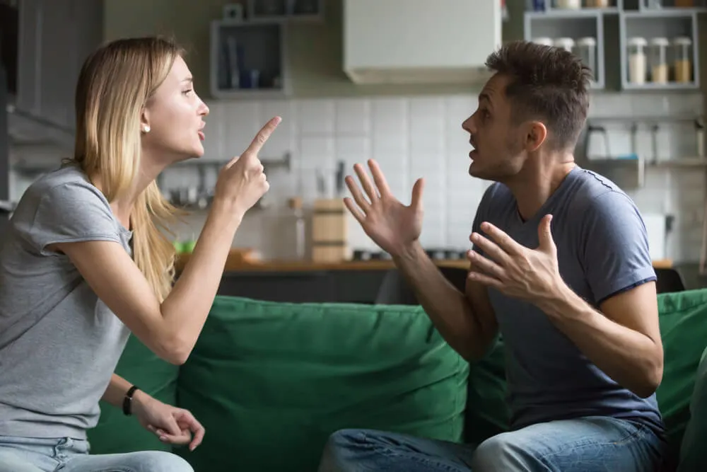 Angry millennial couple arguing shouting blaming each other of problem