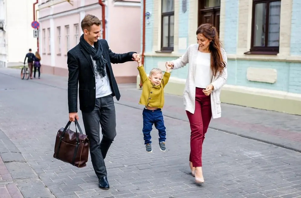 Happy parents with son walking in the city