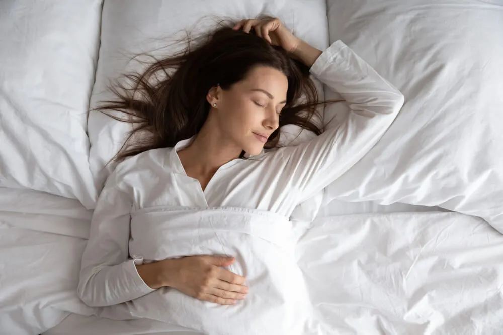 Peaceful serene beautiful young lady wear pajamas lying asleep