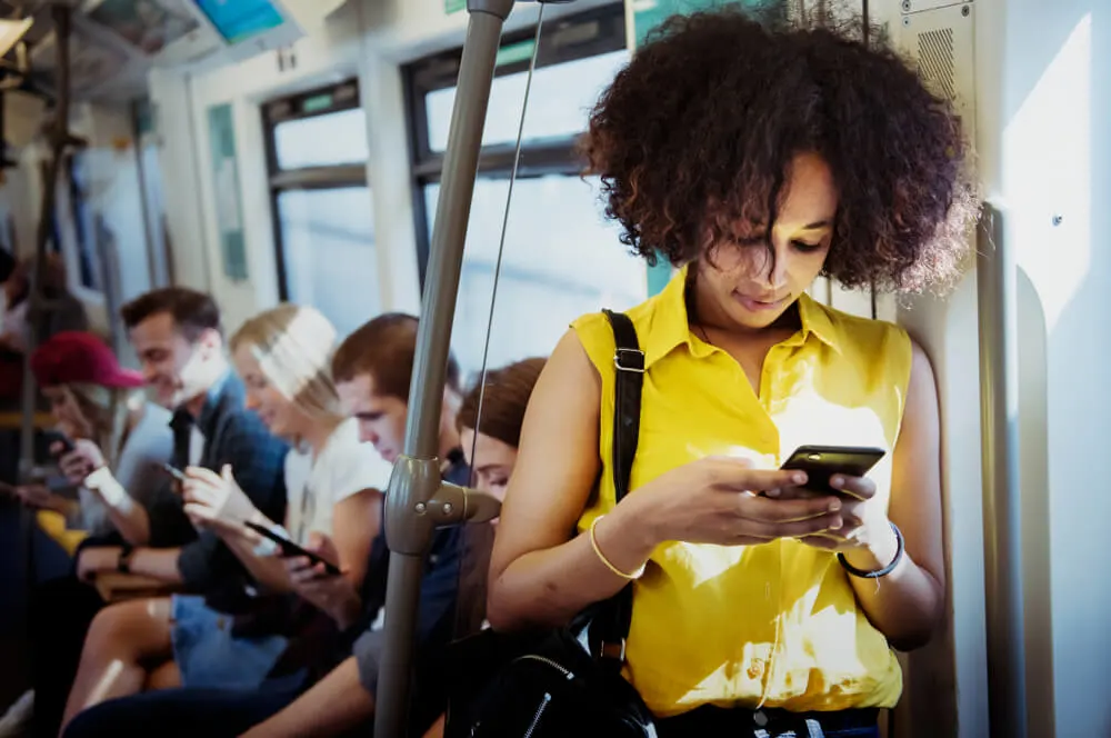 Woman using smartphone in subway