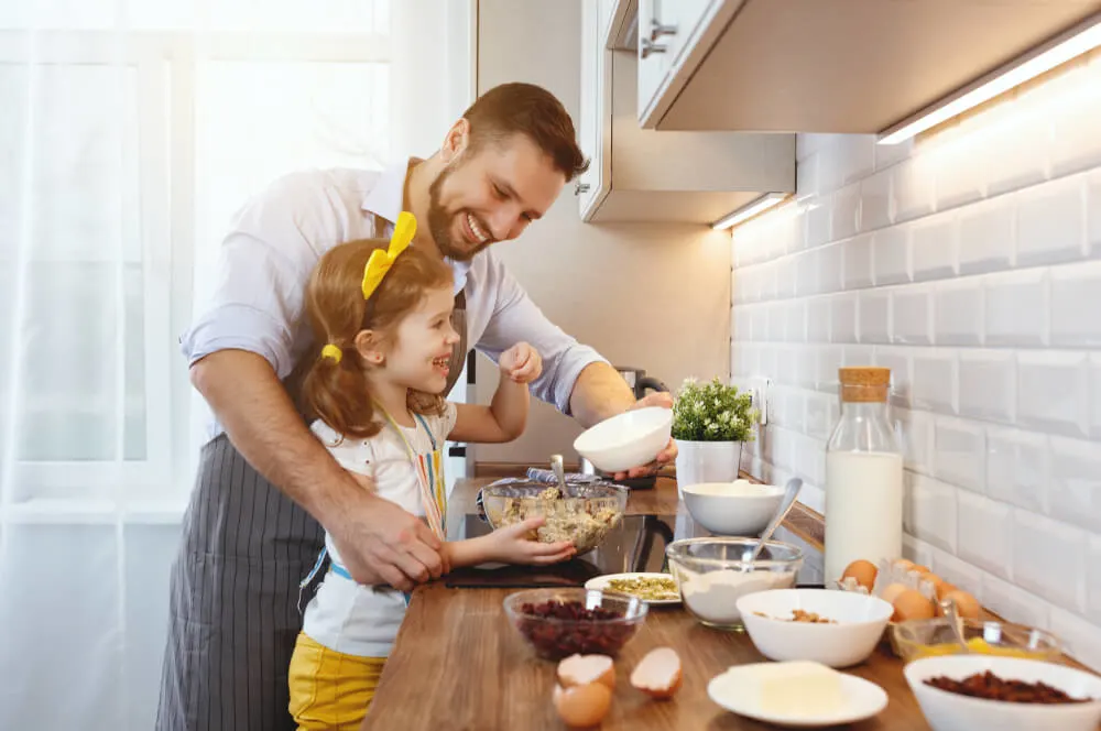 dad and daughter prepare food