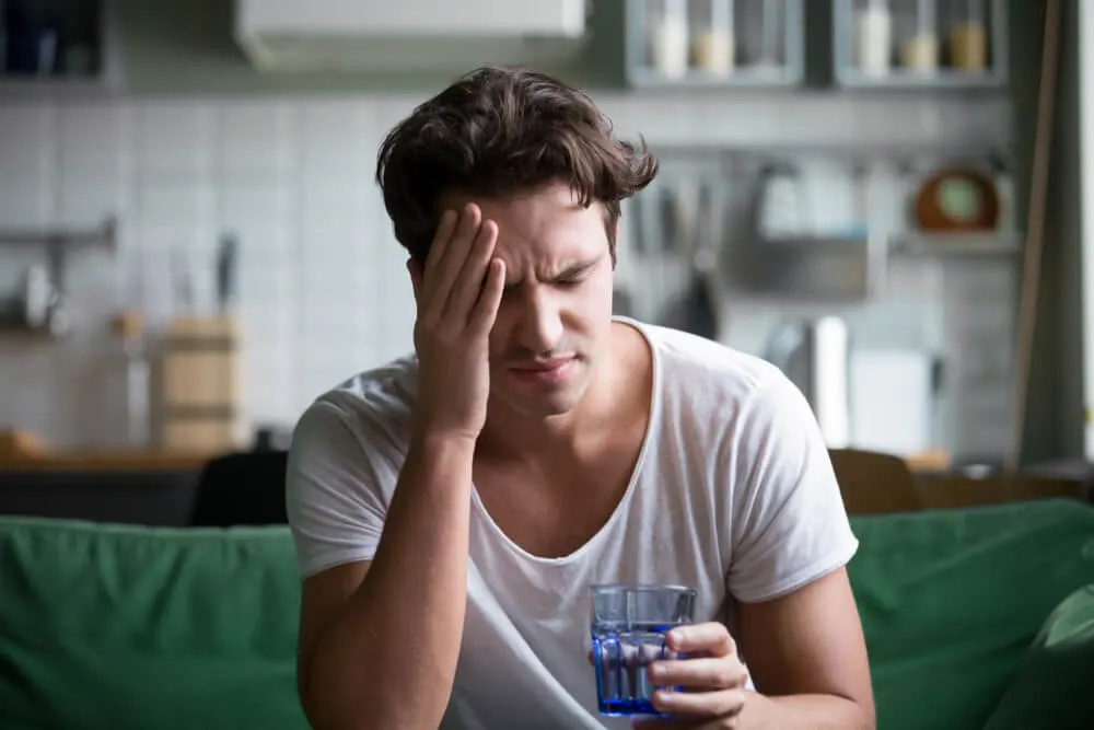 Young man suffering from strong headache