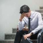 man being depressed by working in office