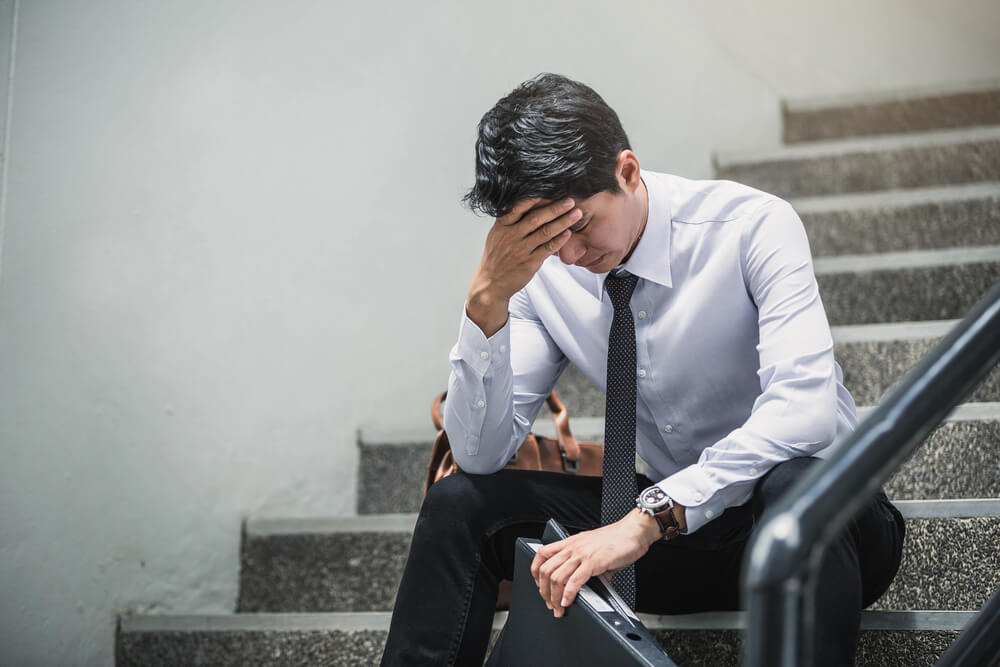 man being depressed by working in office
