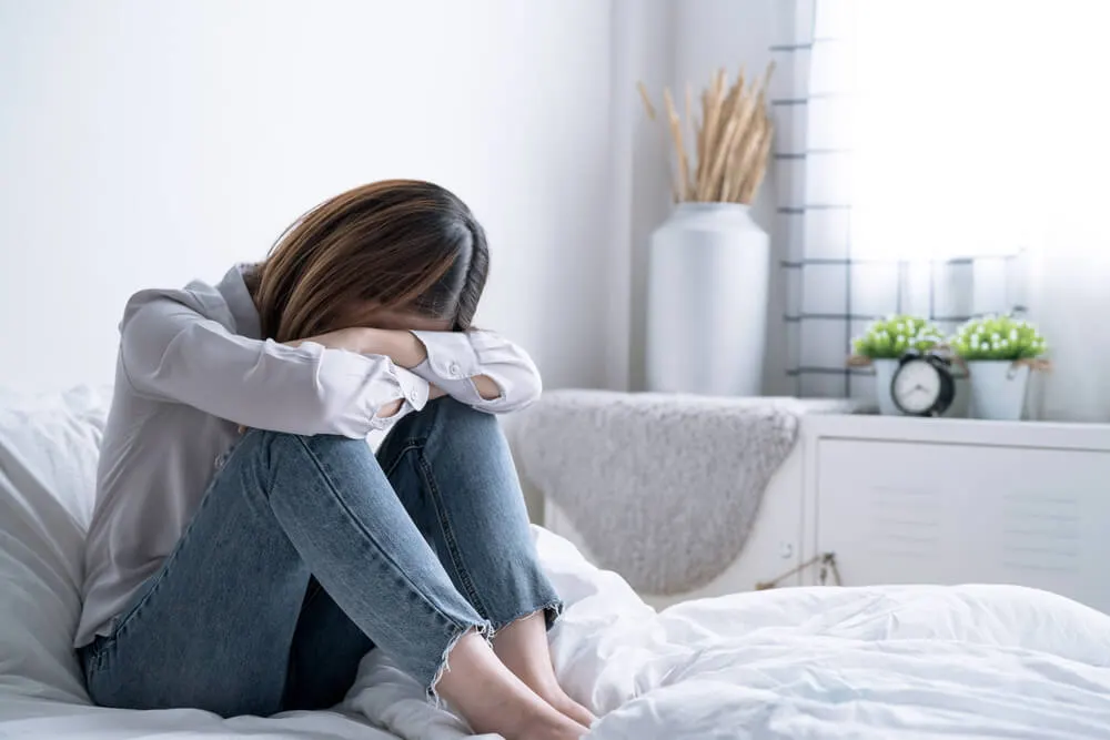 depressed woman in her bedroom