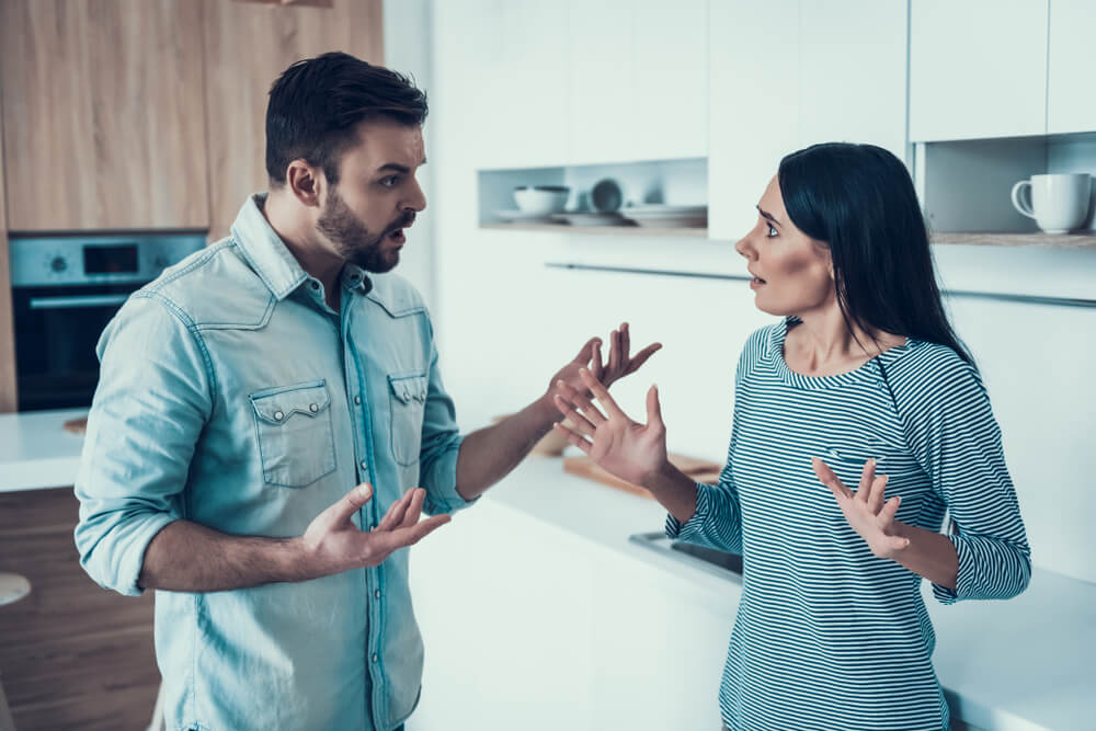 Young couple have disagreement in kitchen at home