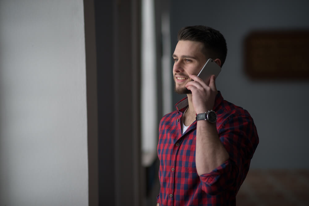 man talking with mother on the phone