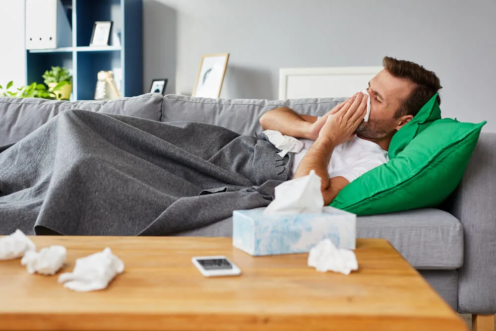Why My Wife Doesn't Care When I'm Sick? 7 Reasons To Consider 1 Sick man lying on sofa at home and blowing nose