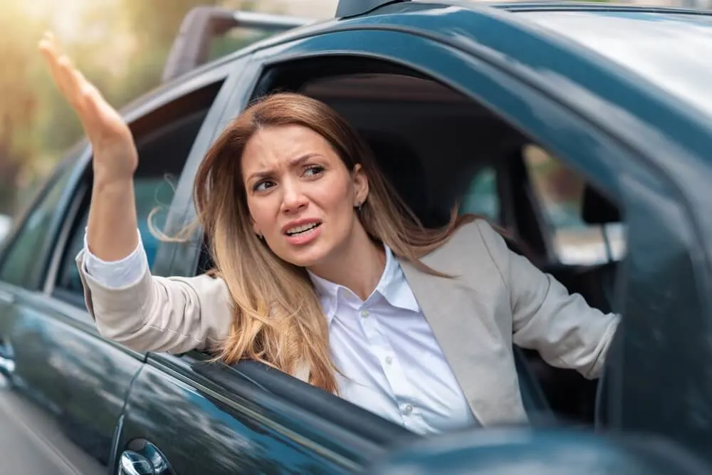 Businesswoman is driving her car very aggressive