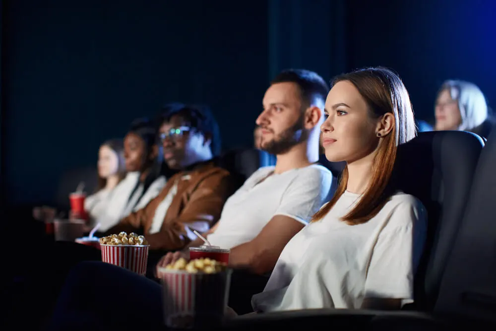 Selective focus of young couple watching movie in cinema
