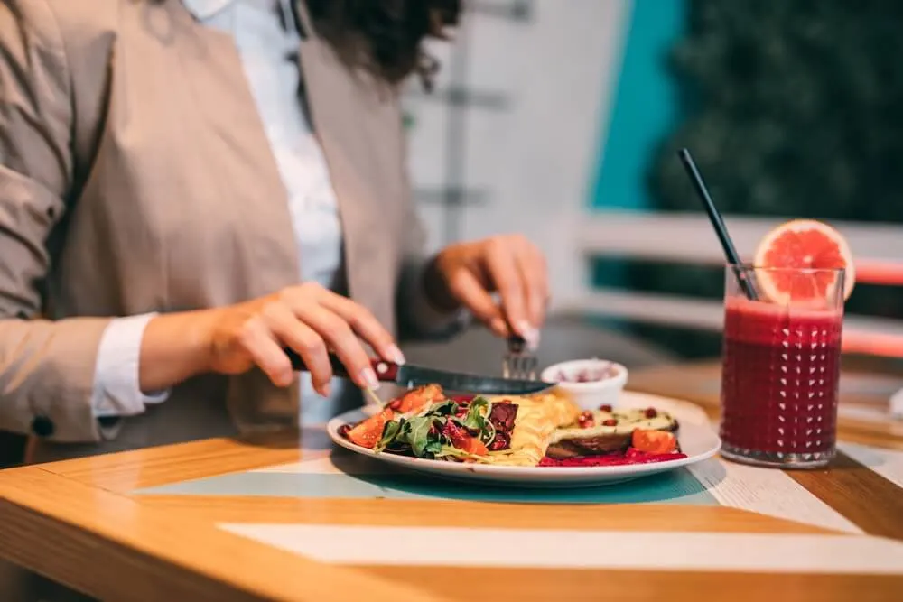 Woman enjoys a healthy meal alone in a restaurant