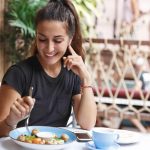 Is it Weird to Go to a Restaurant Alone? 6 Tips For Eating Out Alone 11 girl smiling in a restaurant