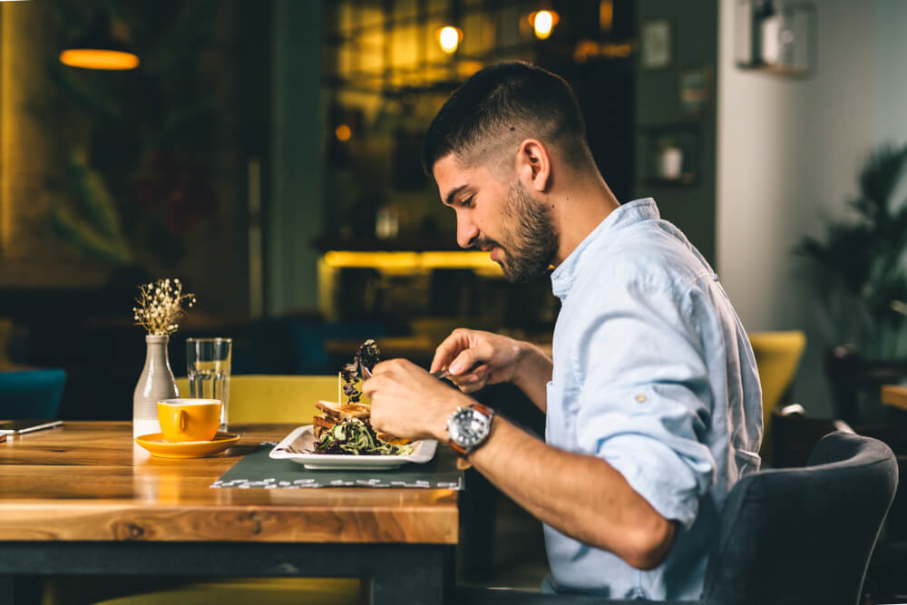 Man having breakfast or dinner in a restairant alone