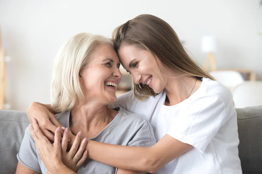 Happy loving older mature mother and grown millennial daughter