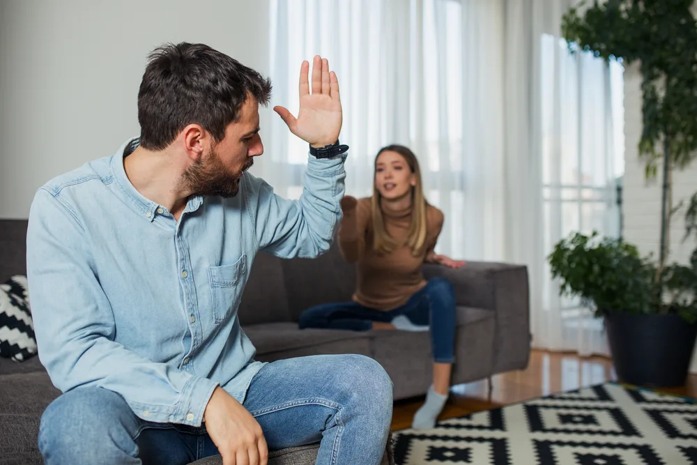 Angry couple arguing at home