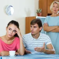 Offended young woman listening to rebukes from mother and husband