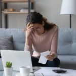 How to Stop Thinking About Lost Money? 5 Ways 4 Unhappy young woman in glasses feeling stressed about lost money